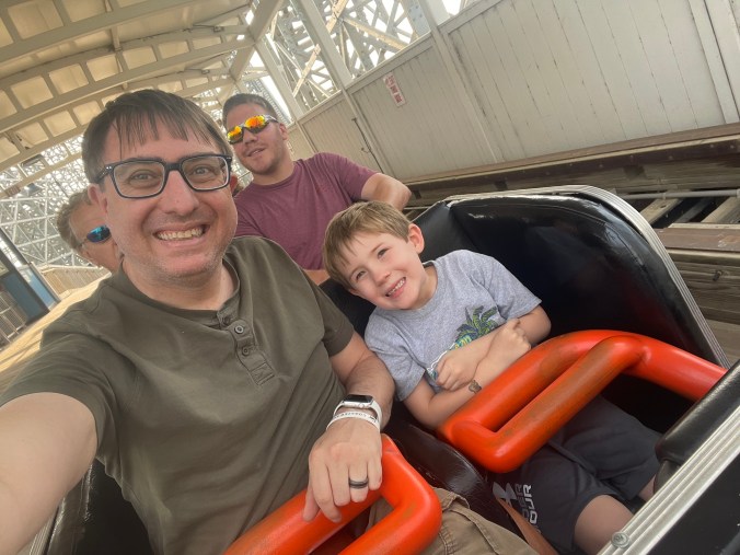 Father and son on Zippin Pippin Roller Coaster
