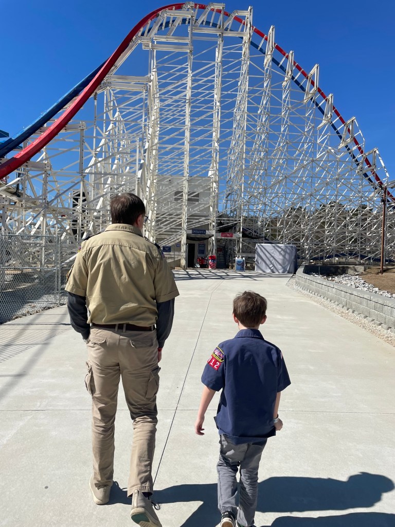 Cub scout and scout leader in front of ArieForce One at Fun Spot Atlanta