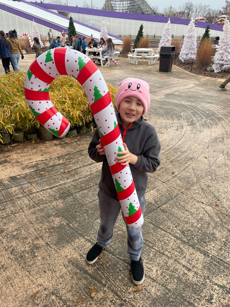 Boy with inflatable candy cane