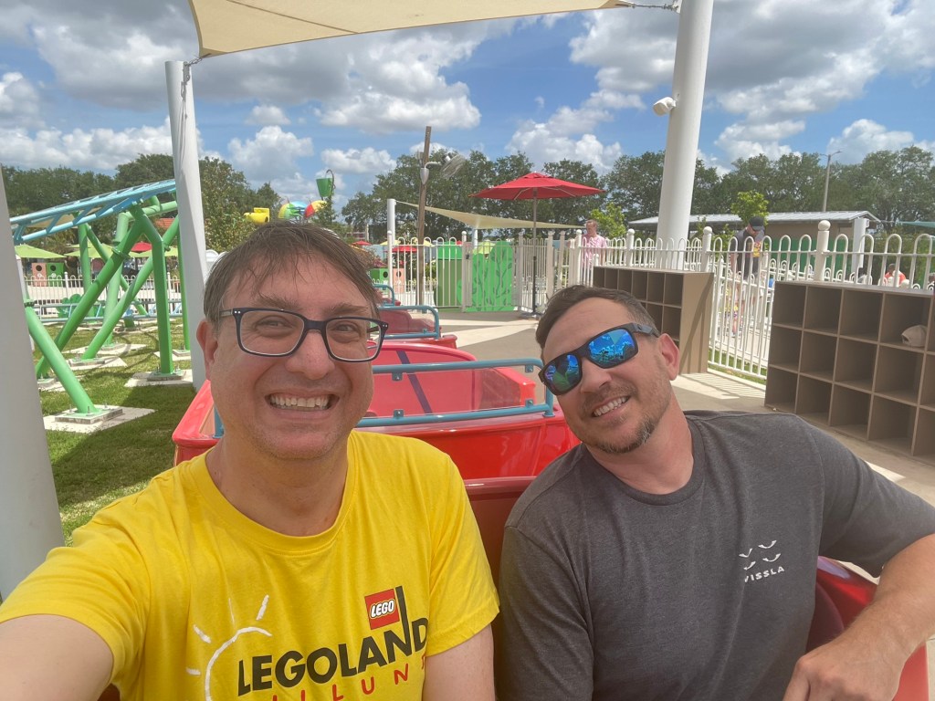Adults on Daddy Pig's Roller Coaster train at Peppa Pig Theme Park