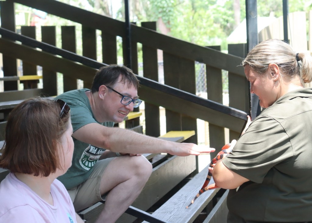 Family at Wild Adventures Swamp Tour with snake