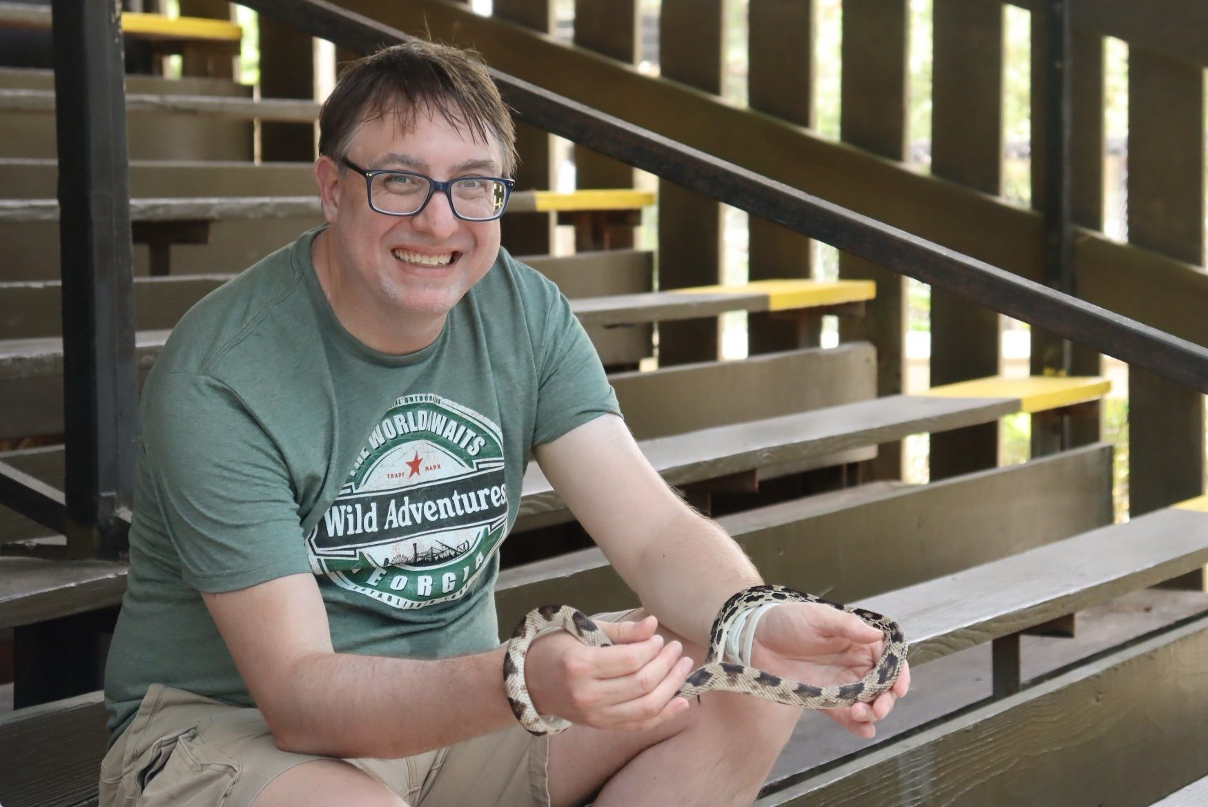 Man holding pine snake at Wild Adventures Swamp Tour