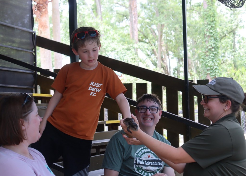 Family at Wild Adventures Swamp Tour with skink