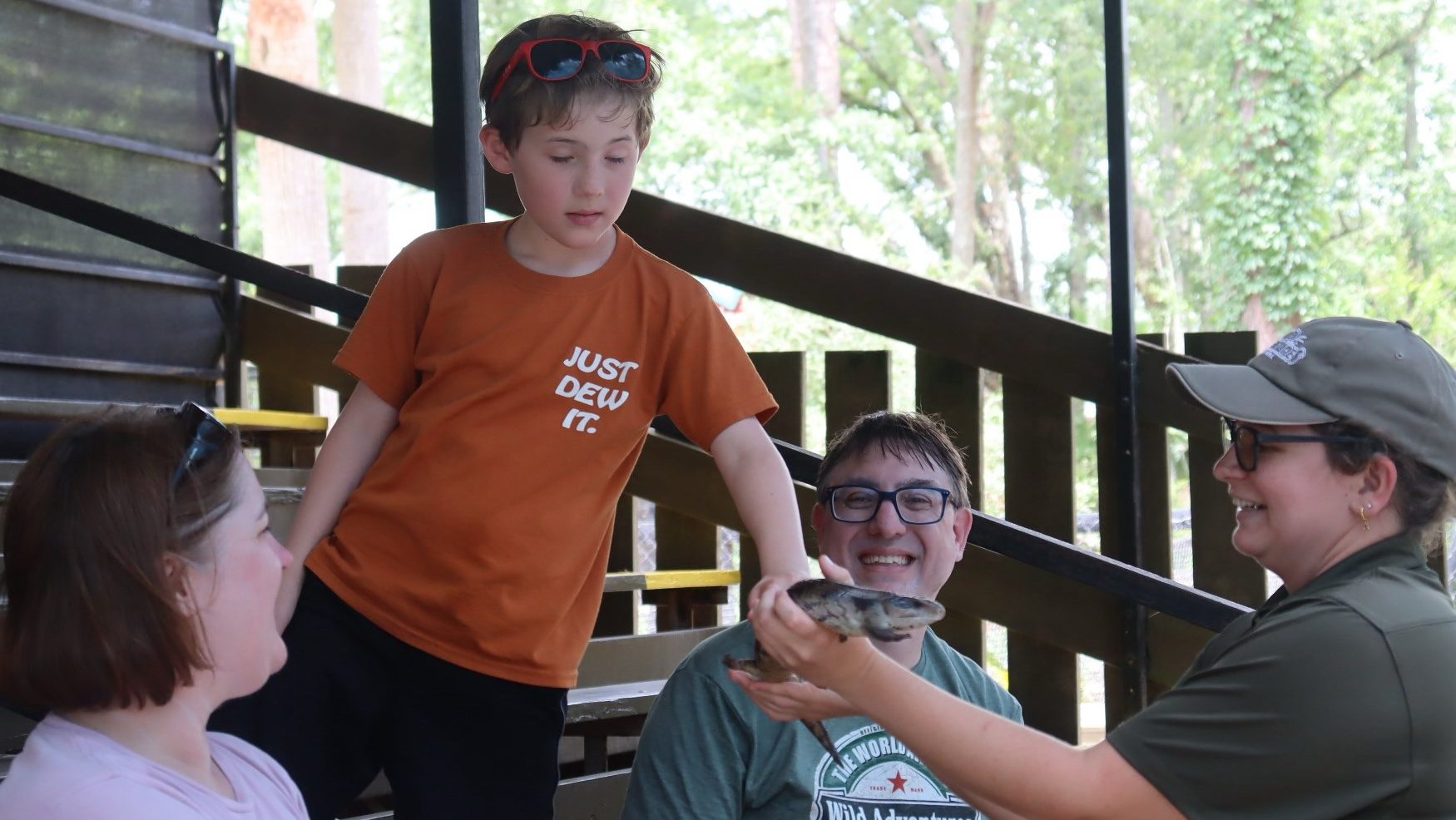 Family at Wild Adventures Swamp Tour with skink