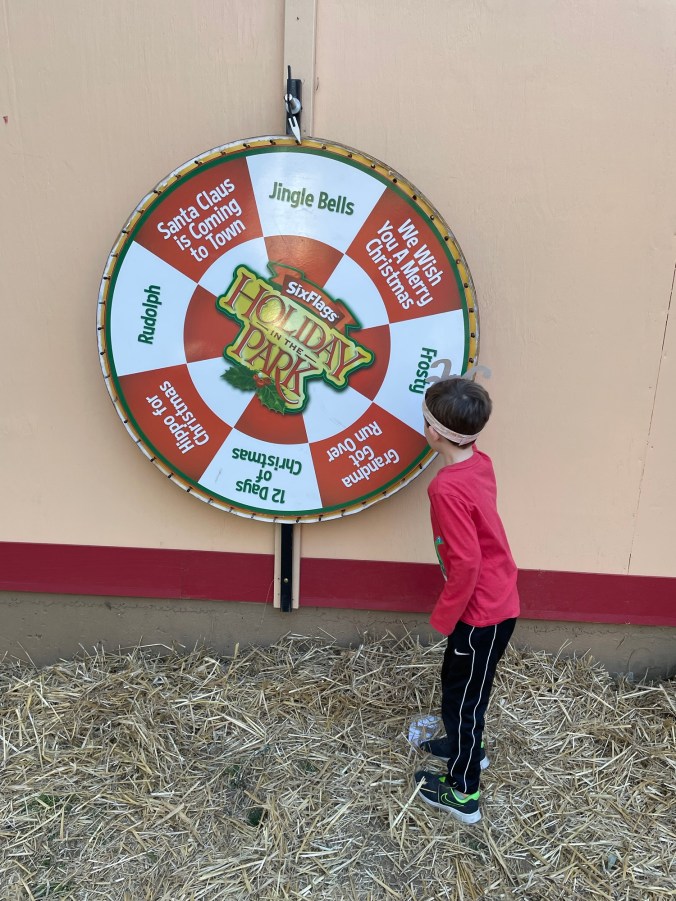 Boy spinning wheel at Six Flags Over Georgia Holiday in the Park