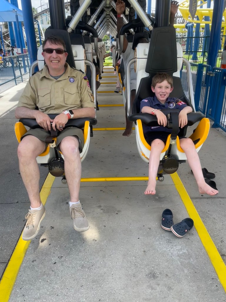 Freedom Flyer roller coaster with scout and scout leader in station at Fun Spot Orlando