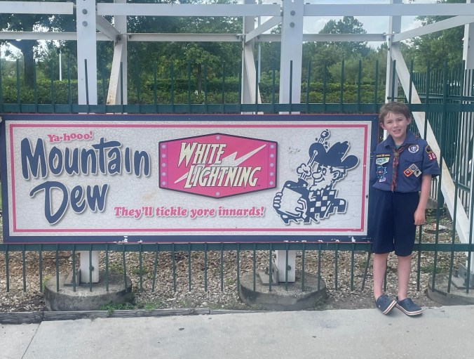 Scout in front of White Lightning sign at Fun Spot Orlando
