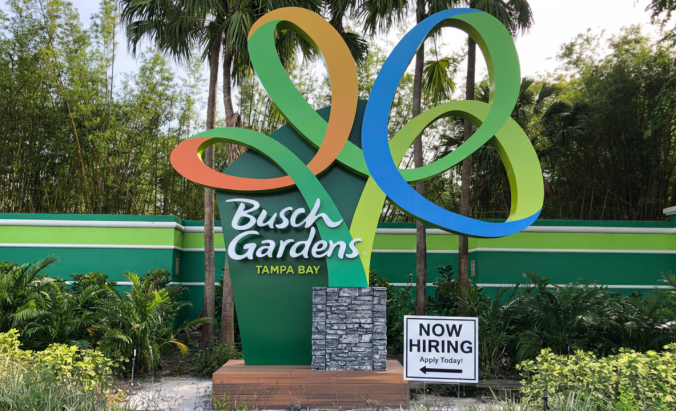 Busch Gardens Tampa sign with now hiring sign in front